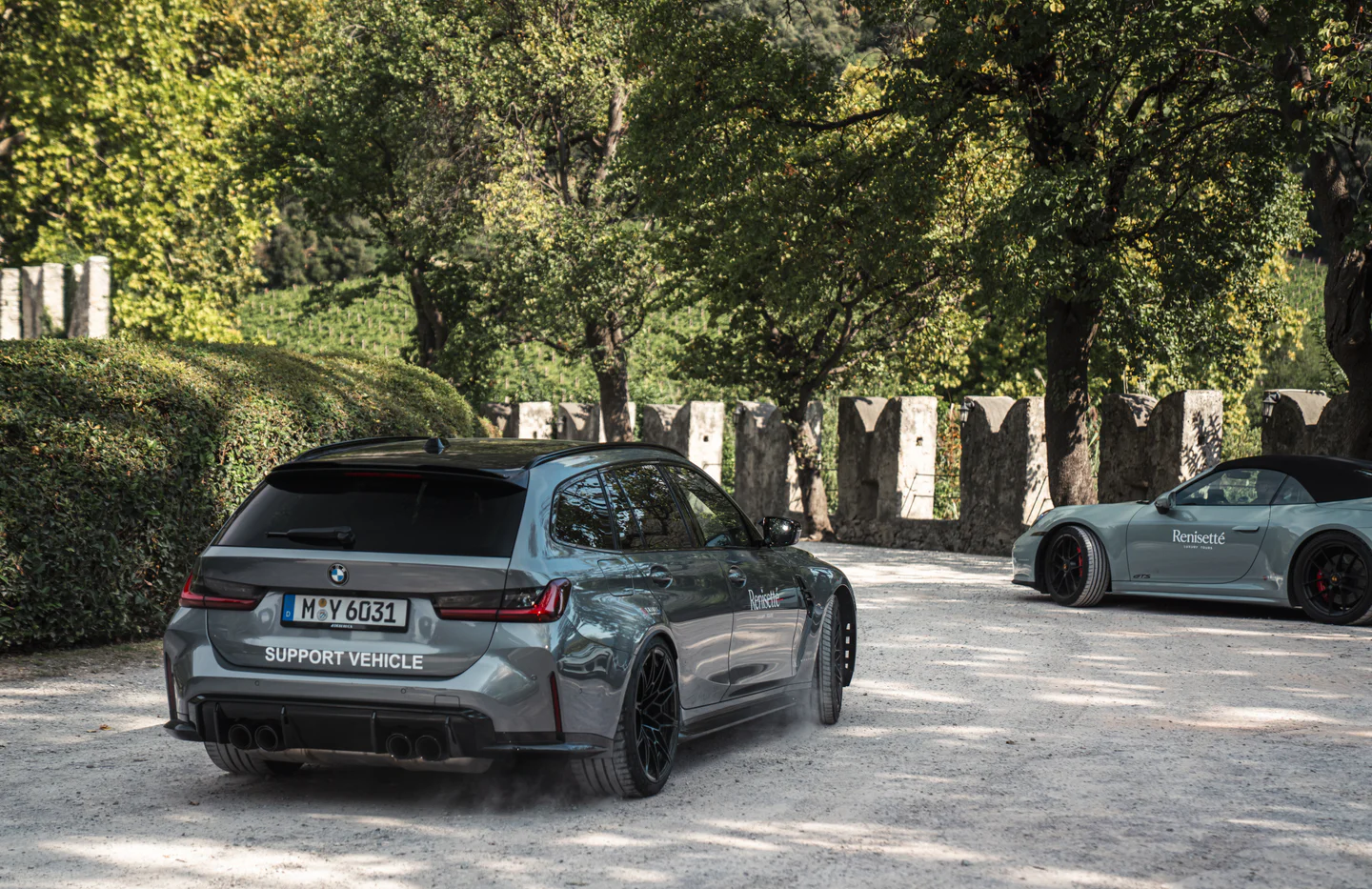Renisetté BMW M3 Touring support vehicle beside a Renisetté-branded Porsche 911 Cabriolet